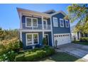 Beautiful blue home with white trim, complemented by manicured landscaping and inviting front porch at 3306 Hartwell St, Johns Island, SC 29455