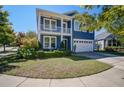 Inviting two-story home with a blue exterior, a charming porch, and well-maintained front lawn at 3306 Hartwell St, Johns Island, SC 29455