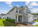 This two-story home with attached garage and a well-maintained lawn at 3802 Grateful Rd, North Charleston, SC 29420