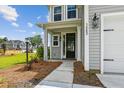 Inviting front entrance with elegant columns and detailed sidelights, creating a warm and welcoming appeal at 3802 Grateful Rd, North Charleston, SC 29420