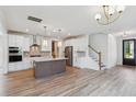 Open-concept kitchen with a center island, stainless steel appliances, and hardwood floors, perfect for entertaining at 3802 Grateful Rd, North Charleston, SC 29420