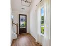 Bright entryway featuring hardwood floors, a view of the outdoors, and lots of natural light at 3806 Grateful Rd, North Charleston, SC 29420