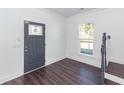 Bright entryway featuring dark wood floors, staircase and a stylish gray door at 405 Simmons Ave, Summerville, SC 29483