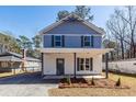 Inviting two-story home boasting a covered front porch and freshly landscaped yard at 405 Simmons Ave, Summerville, SC 29483