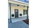 Welcoming front porch with decorative ferns and stylish porch columns at 405 Simmons Ave, Summerville, SC 29483