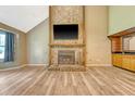 Spacious living room with a floor-to-ceiling stone fireplace, wood-look floors, wet bar, and vaulted ceilings at 4606 Moss Ct, North Charleston, SC 29420