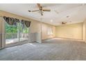 Carpeted bonus room features a ceiling fan, a sliding glass door to a deck, and natural light at 4606 Moss Ct, North Charleston, SC 29420