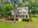 Beautiful home with mature trees on a spacious lot with lush landscaping at 5195 Forest Oaks Dr, Hollywood, SC 29449