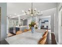 Open-concept dining area with stylish chandelier and wicker chairs near the kitchen at 5195 Forest Oaks Dr, Hollywood, SC 29449