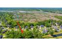 An aerial view showcases the neighborhood, nestled among trees, with marsh views, highlighting the community's serene setting at 5442 Clearview Dr, North Charleston, SC 29420