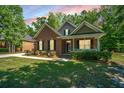 Well-maintained brick home featuring a cozy front porch and neatly trimmed landscaping, set on a green lawn at 5442 Clearview Dr, North Charleston, SC 29420