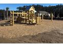 Large wooden playground structure with slides, stairs, and platforms, set on a wood chip surface at 5516 Bowmore Blvd, Ravenel, SC 29470
