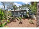 Inviting home showcasing lush greenery, a stone walkway, and a charming, well-maintained facade at 622 E Cooper Ave, Folly Beach, SC 29439