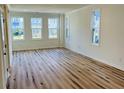 Spacious living room with hardwood floors and large windows that flood the space with natural light at 757 Blueway Ave, Summerville, SC 29486