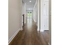 Long hallway with dark wood floors leads to a pair of glass patio doors at 769 Maynard Ln, Summerville, SC 29486