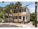 Charming two-story home with black shutters and palm trees at 8 Pitt St # A, Charleston, SC 29401