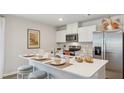 Stylish kitchen featuring white cabinets, stainless steel appliances, and a functional island at 8840 Shovelnose Ct, North Charleston, SC 29406
