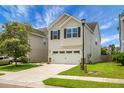 Charming two-story home with a two-car garage, manicured lawn, and classic curb appeal at 8921 Skipping Rock Ln, Summerville, SC 29485