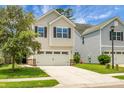 Charming two-story home with a two-car garage, manicured lawn, and classic curb appeal at 8921 Skipping Rock Ln, Summerville, SC 29485