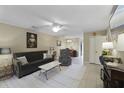 The living room features a ceiling fan, cozy seating, neutral decor, and tile floors at 925 Dills Bluff Rd # 34, Charleston, SC 29412