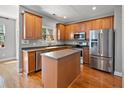 Charming kitchen with stainless steel appliances, a center island, and wooden cabinetry at 9313 Sweetbay Ct, Ladson, SC 29456