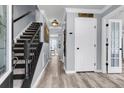 Entryway with staircase and hardwood floors; bright, neutral paint and plenty of natural light at 100 Conset Bay Ct, Goose Creek, SC 29445