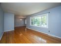 Bright living room with hardwood floors, fresh gray paint, and a large window at 100 S Gum St, Summerville, SC 29483
