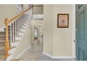 Elegant foyer with a staircase, tile flooring, and a view into the dining area, creating a warm welcome at 103 Trimley Ct, Goose Creek, SC 29445