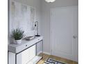 Entryway featuring modern console table decor, artwork, and a minimalist aesthetic by a front door at 115 Lefton Lndg, Summerville, SC 29485
