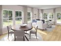 Bright living room with hardwood floors, large windows, stylish furnishings, and plenty of natural light at 115 Lefton Lndg, Summerville, SC 29485