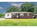 Charming brick and vinyl ranch-style home with a well-manicured lawn and mature trees creating a serene atmosphere at 116 Lyle Rd, Goose Creek, SC 29445