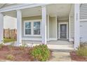 Inviting front porch with white pillars and well-maintained landscaping with healthy plants and reddish brown mulch at 117 Oyster Tide Ave, Summerville, SC 29485