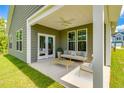 Relaxing covered patio with comfortable seating, a ceiling fan, and backyard access at 119 Crosscut Ln, Summerville, SC 29486