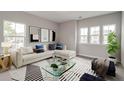 Bright living room with modern decor, large windows, and stylish accents at 119 Crosscut Ln, Summerville, SC 29486