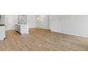 Open-concept living room featuring wood floors and white walls connecting to kitchen, providing an airy feel at 119 Lefton Lndg, Summerville, SC 29485