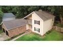 Aerial view of a neat two-story home featuring a brick-facade garage and a pristine, green lawn at 119 Scottswood Dr, North Charleston, SC 29418