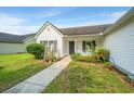Cozy one-story home with a tidy front yard and a welcoming walkway to the front door at 129 Dovetail Cir, Summerville, SC 29483