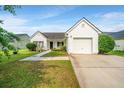 Inviting one-story home with a well-kept lawn and driveway leading to a single-car garage at 129 Dovetail Cir, Summerville, SC 29483