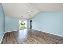 Bright living room with vaulted ceilings, modern ceiling fan, and sliding glass door access at 129 Dovetail Cir, Summerville, SC 29483