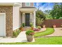 Charming entrance featuring a decorative potted plants and a meticulously landscaped walkway to the front door at 1422 Iroquois St, North Charleston, SC 29405