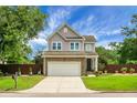 Charming two-story home featuring a brick-accented garage, beautiful lawn, and a manicured front yard at 1422 Iroquois St, North Charleston, SC 29405