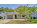 Inviting two-story home with a covered front porch, attached garage, and verdant lawn space at 1743 Orange Grove Shores Dr, Charleston, SC 29407
