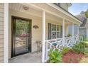 Close-up of the inviting front porch showcasing the home's entrance and charming details at 1743 Orange Grove Shores Dr, Charleston, SC 29407
