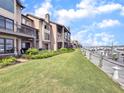 Beautiful condo building with landscaped lawn alongside a boardwalk and marina at 1948 Marsh Oak Ln, Seabrook Island, SC 29455