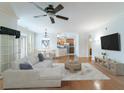 Open-concept living room features hardwood floors, modern furnishings, and views into kitchen at 2000 Belle Isle Ave # 204, Mount Pleasant, SC 29464