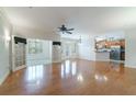 Spacious open-concept living area with hardwood floors and views into a sun room and kitchen at 2000 Belle Isle Ave # 204, Mount Pleasant, SC 29464