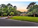 This home boasts a wide lawn, a front porch, dormer windows and a circular driveway at 2040 Shell Ring Cir, Mount Pleasant, SC 29466