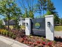 Timothy Lakes entrance sign surrounded by colorful flowers and lush greenery for a welcoming feel at 243 Darby Meadow Ln, Ridgeville, SC 29472
