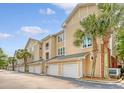 Townhome featuring multiple garages, and palm trees at 260 Seven Farms Dr # 306, Charleston, SC 29492
