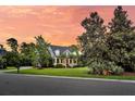 Stunning two-story home boasts mature trees, manicured lawn, and a cozy front porch at 2720 Oak Manor Dr, Mount Pleasant, SC 29466
